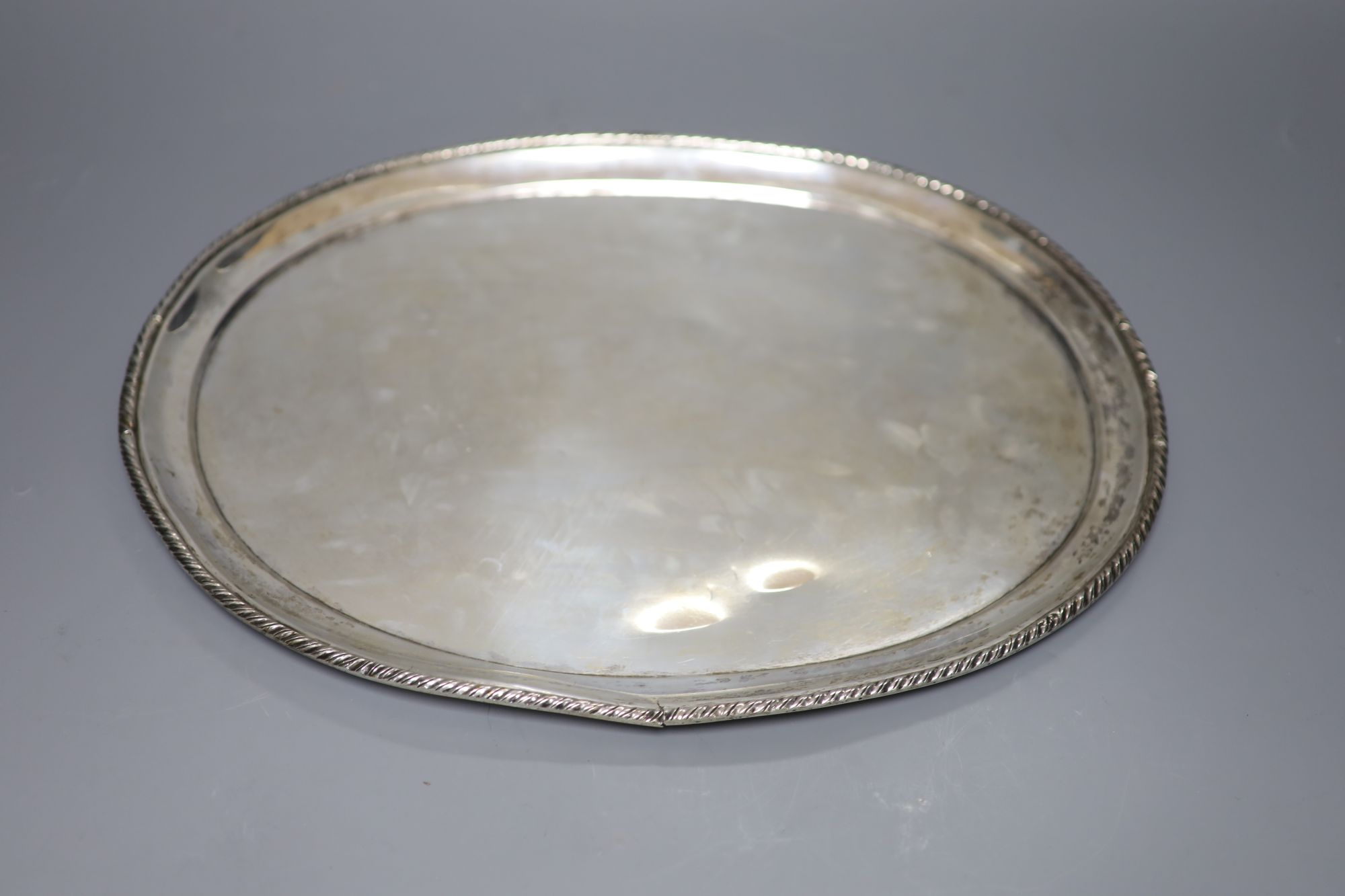 An Italian white metal oval tray with ropetwist edge, 30.5oz